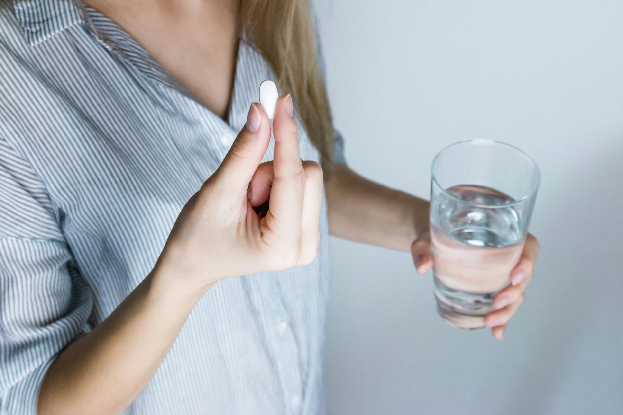 Vortioxetine for Depression – Medication and Dosing Insight Woman holding a pill and glass of water, representing vortioxetine for depression treatment
